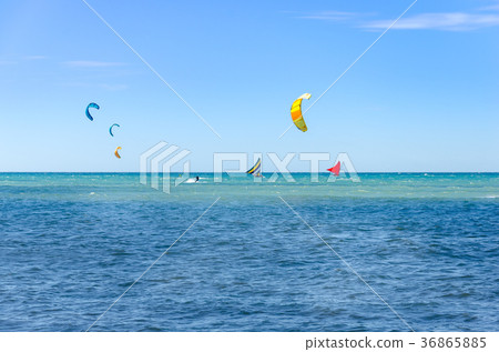 Jangada boat and kite surfers sailing together Jangada boat and kite surfers sailing together 36865885