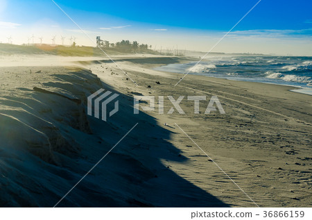 View of a sunset on a white sand beach 36866159