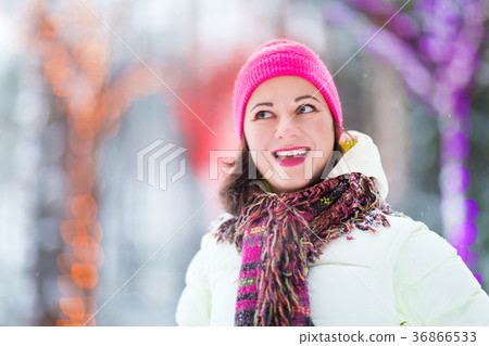 Happy winter women in park snow Christmas lights Happy winter women in park snow Christmas lights 36866533