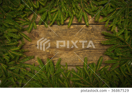 Christmas tree branches on wooden texture Christmas tree branches on wooden texture 36867529
