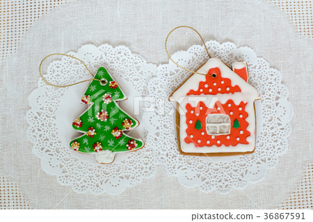 Two gingerbread cookies in the shape of the 36867591