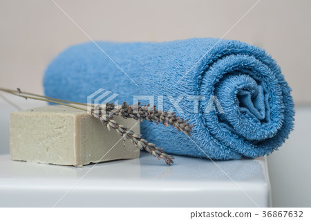 lavender soap and rolled blue towel lavender soap and rolled blue towel 36867632