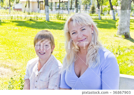 Blond woman and son smiling in the summer Blond woman and son smiling in the summer 36867903