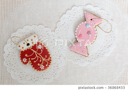 Two gingerbread cookies in the shape of candy and 36868433