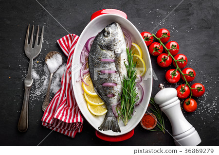 Fresh raw dorado fish with ingredients for cooking Fresh raw dorado fish with ingredients for cooking 36869279