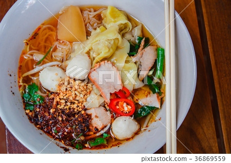 Noodle and dumpling with barbecued red pork. 36869559