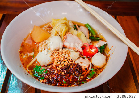 Noodle and dumpling with barbecued red pork. 36869658