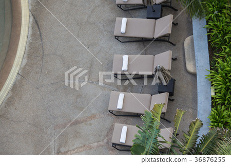 white towel roll on sunbeds at swimming pool 36876255