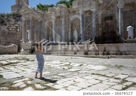 woman traveller photographing agora at ancient city of Sagalassp woman traveller photographing agora at ancient city of Sagalassp 36876527