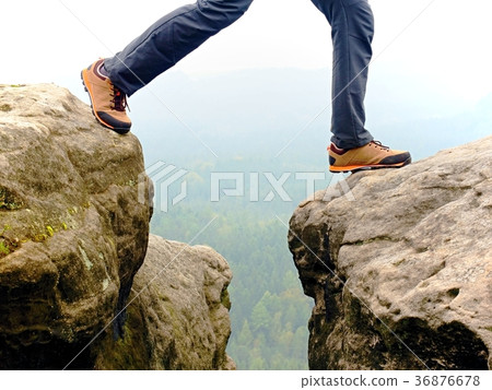 Detail of  hiker legs in black orange hiking boots 36876678