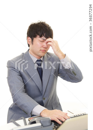A businessman with a tired expression A businessman with a tired expression 36877294