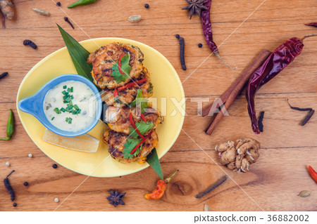 Delicious fish cakes with garlic sauce on side 36882002