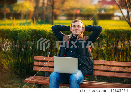 The young manager working on a laptop in the park The young manager working on a laptop in the park 36883984