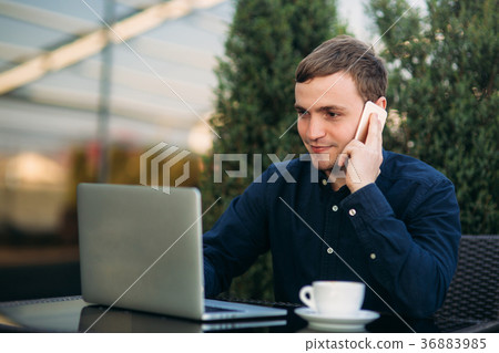 The young manager working on a laptop in the park 36883985