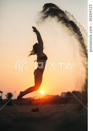 Sexy girl sunbathing on a beach and sits on the 36884525