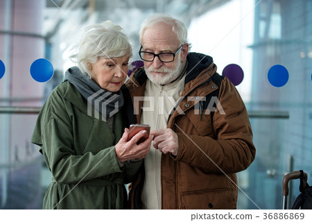 Serious old lady and gentleman are using Serious old lady and gentleman are using 36886869