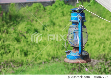 Old blue rusty lantern in the garden Old blue rusty lantern in the garden 36887726