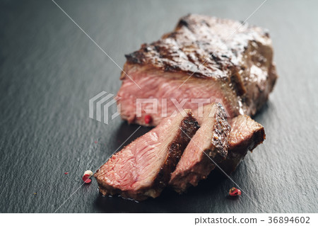 sliced beef steack with pepper on slate board 36894602