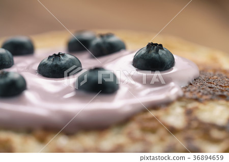 blini or crepes with yogurt and blueberries 36894659