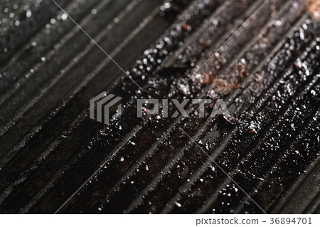 dirty cast iron grill pan after preparing steaks 36894701