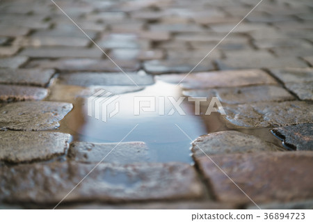 puddle on old stone pavement background puddle on old stone pavement background 36894723