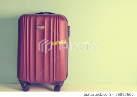Four wheeled hard shell red suitcase 36895603