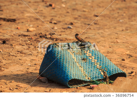 Blue Dirty Torn Plastic Wicker Bag on Ground Blue Dirty Torn Plastic Wicker Bag on Ground 36896754