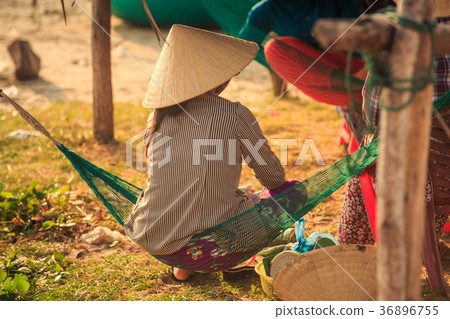 Woman in Straw Hat Sits in Hammock in Vietnam Woman in Straw Hat Sits in Hammock in Vietnam 36896755