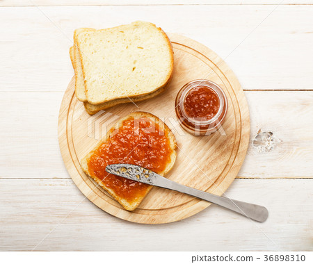 Jar of peach jam with bread Jar of peach jam with bread 36898310
