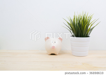 a pink piggy bank on desk wood 36898610
