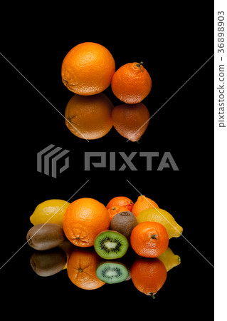 orange and other fruits on a black background 36898903