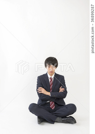 Young businessman with arms folded in throne 36899287