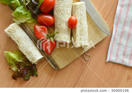 bread roll and salad on wooden chop block bread roll and salad on wooden chop block 36900196