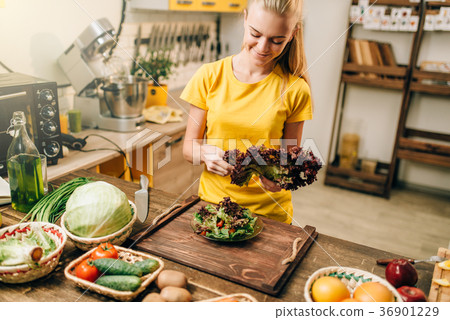 Happy woman holding salad, cooking healthy food Happy woman holding salad, cooking healthy food 36901229