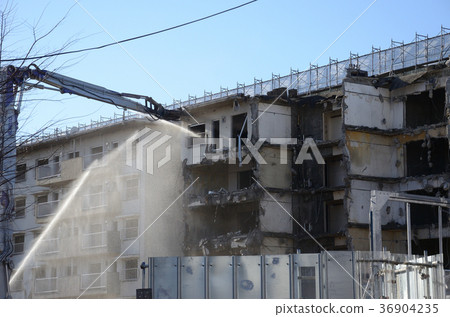 Dismantling work site, water discharge for dust control. 36904235