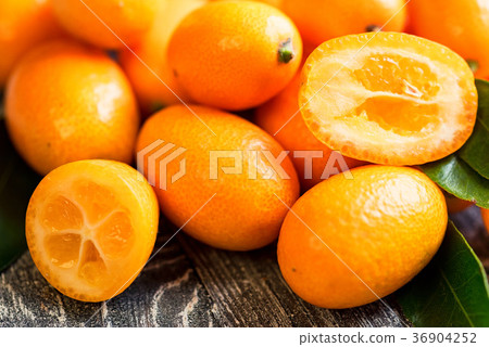 Kumquat or cumquat on wooden table 36904252