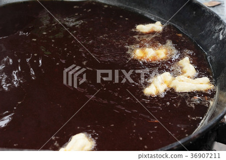 Making deep-fried dough stick in market. Making deep-fried dough stick in market. 36907211