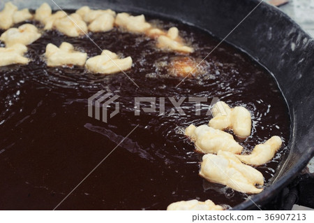 Making deep-fried dough stick in market. Making deep-fried dough stick in market. 36907213