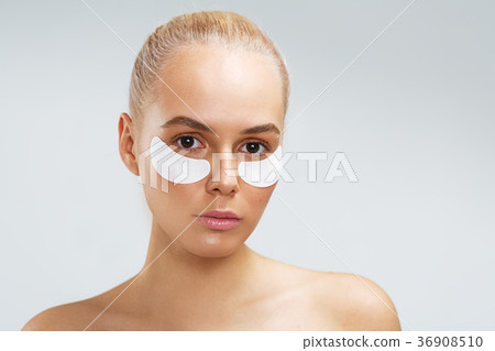 Beauty shot of a young woman with undereye mask Beauty shot of a young woman with undereye mask 36908510