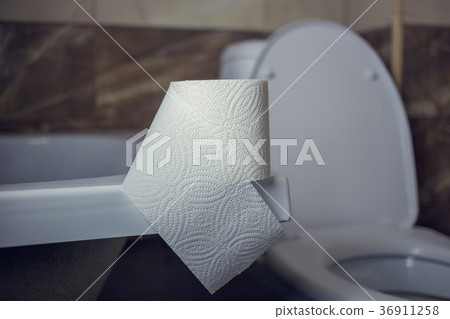 Toilet paper roll on the edge of the bath. On the Toilet paper roll on the edge of the bath. On the 36911258
