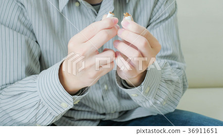 man breaking a cigarette 36911651