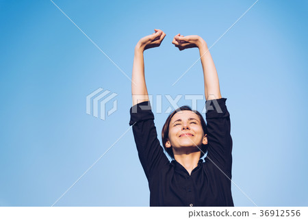 Woman relaxing under the blue sky Woman relaxing under the blue sky 36912556