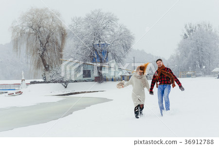 Two happy loving people are holding hands while Two happy loving people are holding hands while 36912788