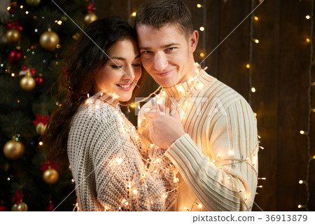young couple together in christmas decoration young couple together in christmas decoration 36913879