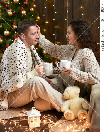 young couple together in christmas decoration young couple together in christmas decoration 36913920