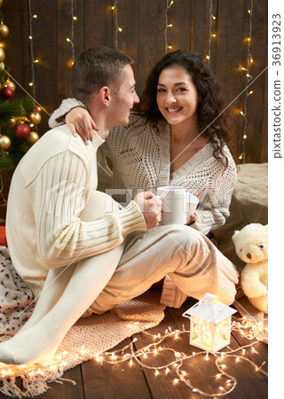 young couple together in christmas decoration young couple together in christmas decoration 36913923