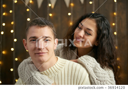young couple together in christmas lights young couple together in christmas lights 36914120