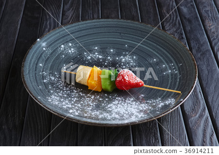 Fresh banana, orange, kiwi, strawberry on skewer 36914211