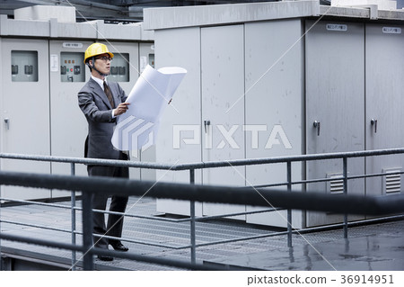A businessman wearing a helmet A businessman wearing a helmet 36914951