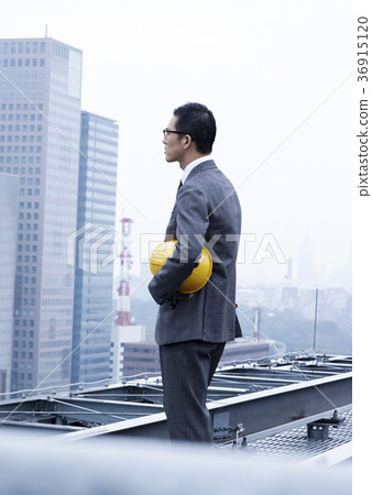 Businessman standing on the roof Businessman standing on the roof 36915120
